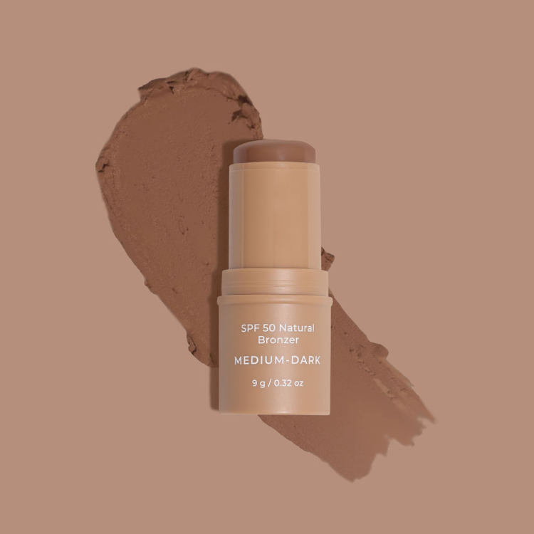 SPF 50 Natural Bronzer stick with a swatch on a brown background