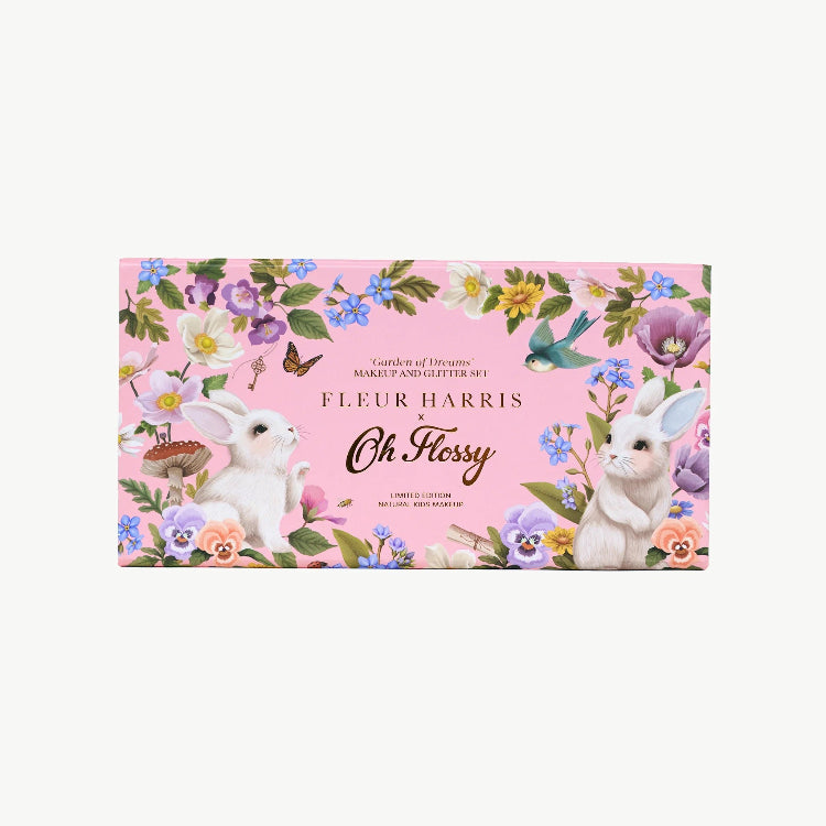 Fleur Harris makeup set with rabbits and flowers on a pink background