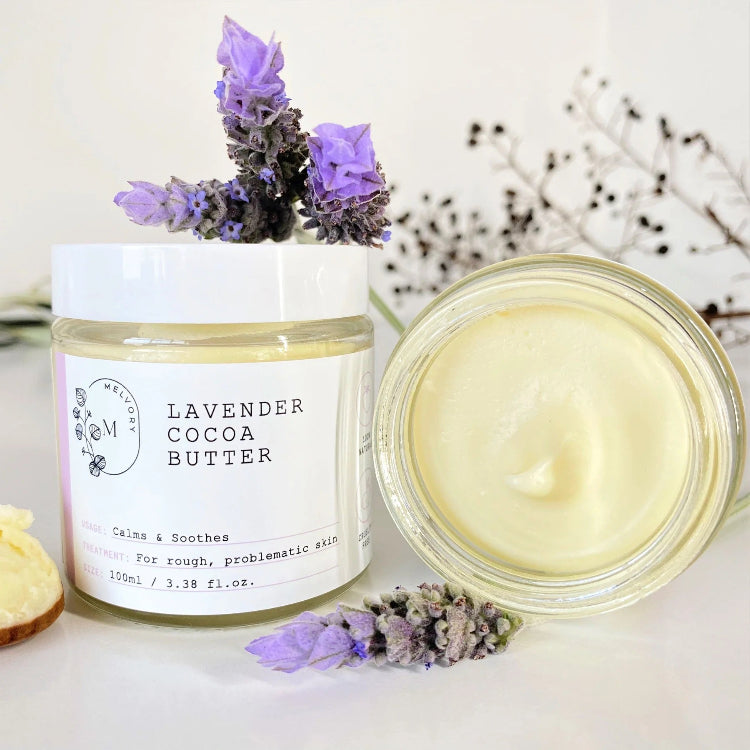 Lavender cocoa butter product with a jar and open container on a white background