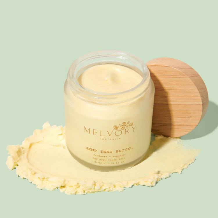 Jar of Melvory hemp seed butter with a wooden lid on a light green background