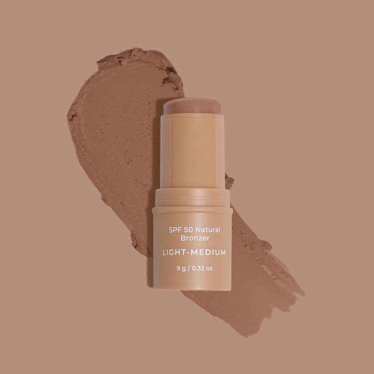 SPF 50 Natural Bronzer stick with a swatch on a brown background